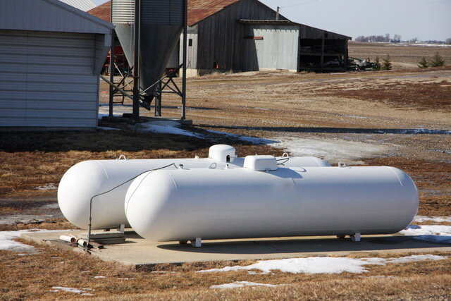 Propane tanks behind garage on small farm