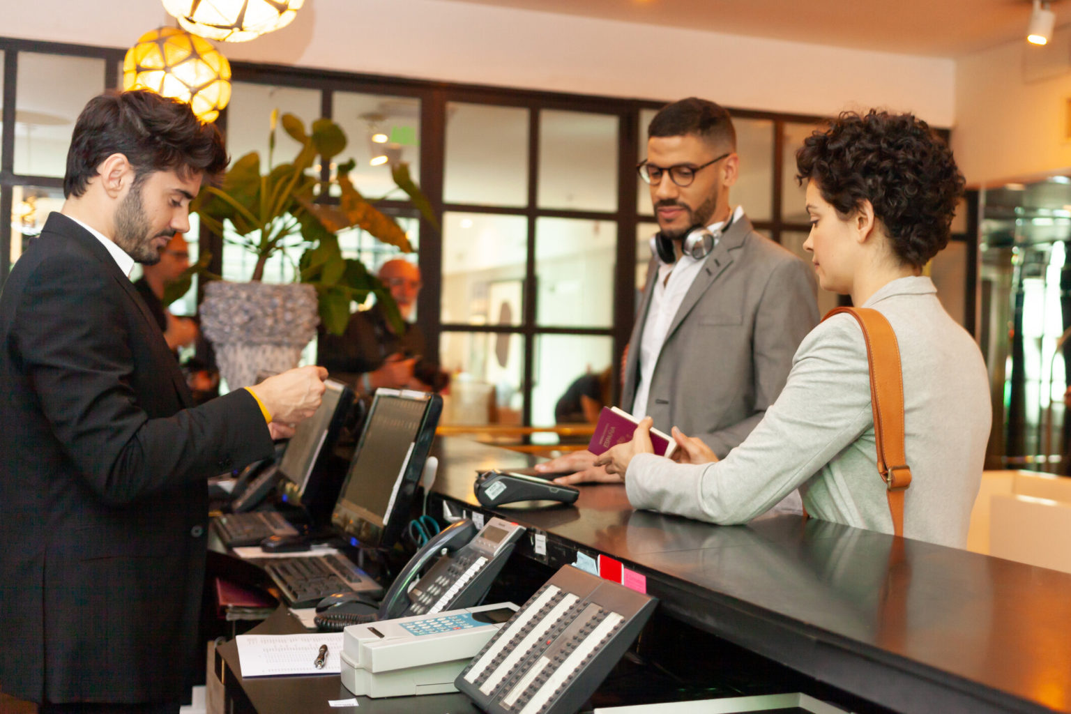 Couple checking in to hotel at the front desk