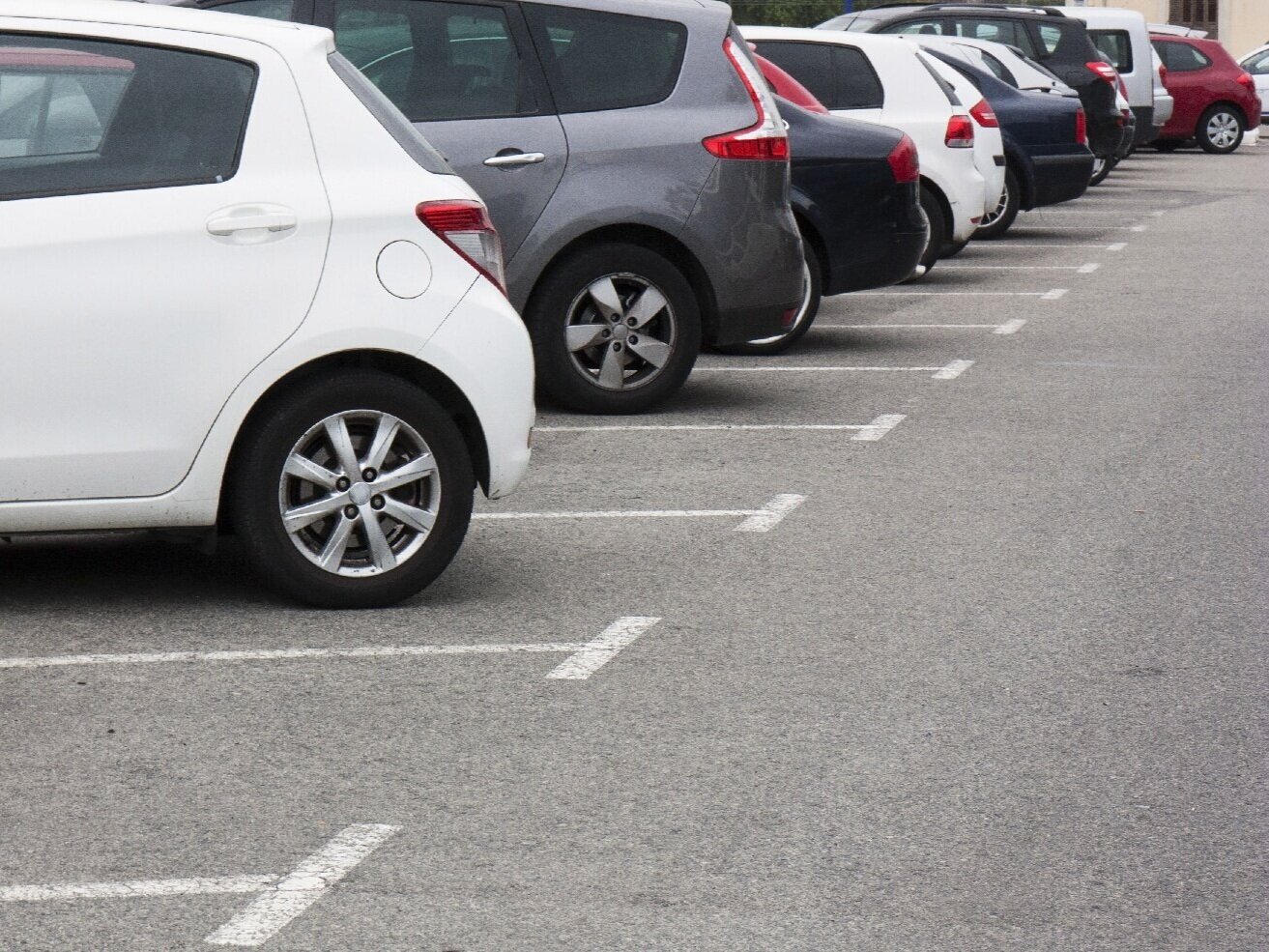 Parking lot spaces full with vehicles