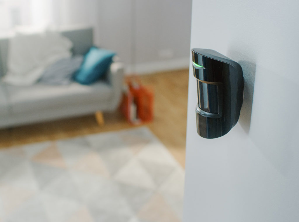 Environmental sensor mounted on a wall in a hotel room